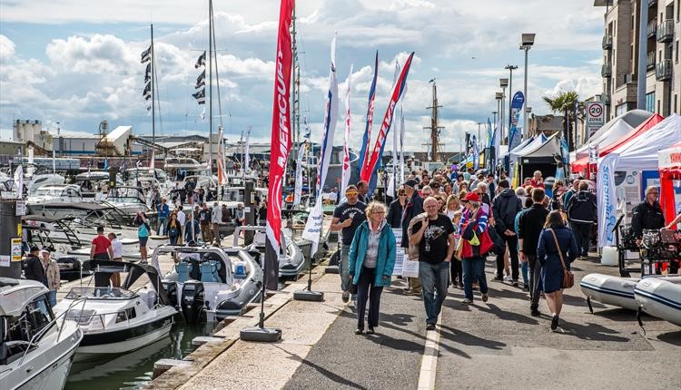 Crowds of people walking along taking in the Poole Harbour Boat Show